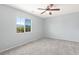 Bright bedroom with plush carpet and a ceiling fan, offering tranquil views from the window at 6013 Jubilee Gardens Ave, Las Vegas, NV 89131