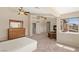 Bedroom featuring a fireplace, ceiling fans, large windows and a wooden dresser on plush carpeting at 6013 Jubilee Gardens Ave, Las Vegas, NV 89131