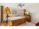 Furnished bedroom with a custom bed frame, wooden furnishings and ambient lighting from a unique table lamp at 6013 Jubilee Gardens Ave, Las Vegas, NV 89131