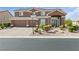 Charming two-story home featuring a three-car garage, beautiful landscaping, and a welcoming entrance at 6013 Jubilee Gardens Ave, Las Vegas, NV 89131