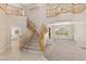 Bright, open foyer with staircase, large windows, and elegant chandelier for a grand entrance at 6013 Jubilee Gardens Ave, Las Vegas, NV 89131