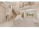 Bright, open foyer with staircase, large windows, and elegant chandelier for a grand entrance at 6013 Jubilee Gardens Ave, Las Vegas, NV 89131
