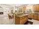 Well-equipped kitchen with granite bar, stainless steel sink, and views into the living and dining areas at 6013 Jubilee Gardens Ave, Las Vegas, NV 89131