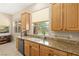Well-lit kitchen featuring bright granite countertops and tiled flooring at 6013 Jubilee Gardens Ave, Las Vegas, NV 89131
