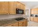 Modern kitchen with granite countertops, stainless steel appliances and tile floors at 6013 Jubilee Gardens Ave, Las Vegas, NV 89131