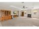 Expansive living room with fireplace, built-in cabinets, and tray ceiling, perfect for entertaining at 6013 Jubilee Gardens Ave, Las Vegas, NV 89131