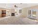 Spacious living room with a cozy fireplace, french doors, and neutral tones for a warm ambiance at 6013 Jubilee Gardens Ave, Las Vegas, NV 89131