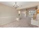 Open living room showcasing high ceilings, abundant natural light, elegant chandelier, and staircase access at 6013 Jubilee Gardens Ave, Las Vegas, NV 89131