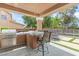 Inviting outdoor kitchen and bar area with a built-in grill, set against the backdrop of a sparkling pool at 6013 Jubilee Gardens Ave, Las Vegas, NV 89131