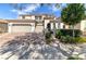 Stunning two-story home featuring a three-car garage, well-manicured lawn, and beautiful architectural details at 606 Cadence Vista Dr, Henderson, NV 89011