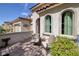 Inviting front porch featuring textured walls, comfortable seating, and picturesque garden views at 606 Cadence Vista Dr, Henderson, NV 89011