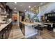 Modern kitchen with granite countertops, dark cabinets, stainless steel appliances, and an open layout at 606 Cadence Vista Dr, Henderson, NV 89011