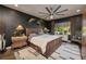 Comfortable bedroom with a ceiling fan, decorative lamps, and accent furniture to showcase a relaxing space at 606 Cadence Vista Dr, Henderson, NV 89011