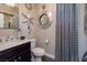 Stylish powder room featuring modern fixtures, a statement mirror, and elegant design elements at 606 Cadence Vista Dr, Henderson, NV 89011