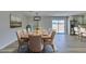 Elegant dining room with seating for eight, modern light fixture and sliding glass door at 6100 Fawn Cir, Las Vegas, NV 89107