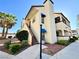 Exterior view of a two-story condo showcasing desert landscaping and private stairs at 6137 W Oakey Blvd # A, Las Vegas, NV 89146
