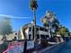 Exterior view of a condo complex with palm trees and assigned parking signage at 6137 W Oakey Blvd # A, Las Vegas, NV 89146
