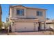 New two-story home with a two car garage, paver driveway, and desert landscaping at 6787 Magnolia River Ave, Las Vegas, NV 89156
