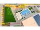 Aerial view of resort-style backyard with pool, spa, covered patio, lush landscaping, and plenty of space for outdoor enjoyment at 6980 W Meranto Ave, Las Vegas, NV 89178