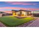 Beautiful backyard featuring synthetic grass, a putting green, and a cozy patio area for outdoor relaxation and entertainment at 6980 W Meranto Ave, Las Vegas, NV 89178