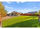 Large grassy backyard with well-maintained landscaping and outdoor seating, perfect for relaxation and recreation at 6980 W Meranto Ave, Las Vegas, NV 89178