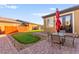 Landscaped backyard featuring a putting green, patio with furniture, and view of the home at 6980 W Meranto Ave, Las Vegas, NV 89178