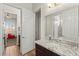 Bathroom showcasing a granite countertop and views into a nearby decorated bedroom at 6980 W Meranto Ave, Las Vegas, NV 89178