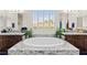 Bright bathroom features a soaking tub with stylish granite surround, double sinks, and natural light at 6980 W Meranto Ave, Las Vegas, NV 89178