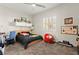 Bright bedroom featuring a ceiling fan, plush carpet, and a window providing natural light at 6980 W Meranto Ave, Las Vegas, NV 89178