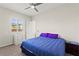 Well-lit bedroom featuring a ceiling fan, window with shutters, and neutral paint at 6980 W Meranto Ave, Las Vegas, NV 89178