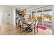 Dining area with glass sliding doors, pool views, wine storage, and decorative hanging plants at 6980 W Meranto Ave, Las Vegas, NV 89178