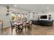 Elegant dining area with sliding glass doors, and views of the living area and backyard at 6980 W Meranto Ave, Las Vegas, NV 89178