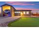 Exterior of home showcasing RV garage, putting green, desert landscaping, and paved driveway at 6980 W Meranto Ave, Las Vegas, NV 89178