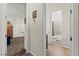This hallway leads to a bedroom and bathroom with wood floors at 6980 W Meranto Ave, Las Vegas, NV 89178