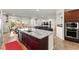 Open concept kitchen view showcasing granite counters, cherry cabinets, and adjacent living space at 6980 W Meranto Ave, Las Vegas, NV 89178