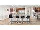 Modern kitchen island with granite countertops and seating for four, and stainless steel appliances at 6980 W Meranto Ave, Las Vegas, NV 89178