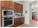 Gourmet kitchen featuring stainless steel appliances, and warm wooden cabinetry at 6980 W Meranto Ave, Las Vegas, NV 89178