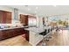 Modern kitchen featuring granite countertops, stainless steel appliances, and a breakfast bar with seating at 6980 W Meranto Ave, Las Vegas, NV 89178