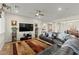 Spacious living room with a large leather couch, ceiling fan, and colorful area rug at 6980 W Meranto Ave, Las Vegas, NV 89178