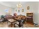 Cozy living room with wood-look tile floors, sofas, and bookshelf at 6980 W Meranto Ave, Las Vegas, NV 89178