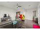 Open living room with wood floors, a kitchenette, and a ceiling fan at 6980 W Meranto Ave, Las Vegas, NV 89178