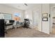 Large carpeted office features a ceiling fan, white board, and abundant natural light through the window at 6980 W Meranto Ave, Las Vegas, NV 89178