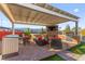 Outdoor kitchen with stainless steel appliances, bar seating, and a built-in grill is perfect for summer entertaining at 6980 W Meranto Ave, Las Vegas, NV 89178