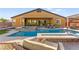 Inviting backyard pool and spa with lounge chairs and a covered patio offers a relaxing outdoor oasis at 6980 W Meranto Ave, Las Vegas, NV 89178