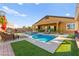 Stunning pool and spa with lush artificial grass and outdoor seating area, perfect for entertaining and relaxation at 6980 W Meranto Ave, Las Vegas, NV 89178