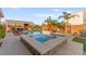 Backyard oasis with a pool, spa, outdoor kitchen, and patio area, perfect for entertaining guests at 6980 W Meranto Ave, Las Vegas, NV 89178