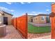 A charming side yard with artificial turf putting green offers a fun and relaxing outdoor amenity at 6980 W Meranto Ave, Las Vegas, NV 89178