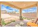 Comfortable covered patio overlooking the spacious backyard, ideal for outdoor enjoyment at 7045 Judith River St, North Las Vegas, NV 89084