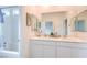 Bright bathroom features a double sink vanity with modern fixtures, shower and neutral walls at 7045 Judith River St, North Las Vegas, NV 89084