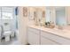 Bright bathroom features a double sink vanity with modern fixtures, shower and natural light from the window at 7045 Judith River St, North Las Vegas, NV 89084
